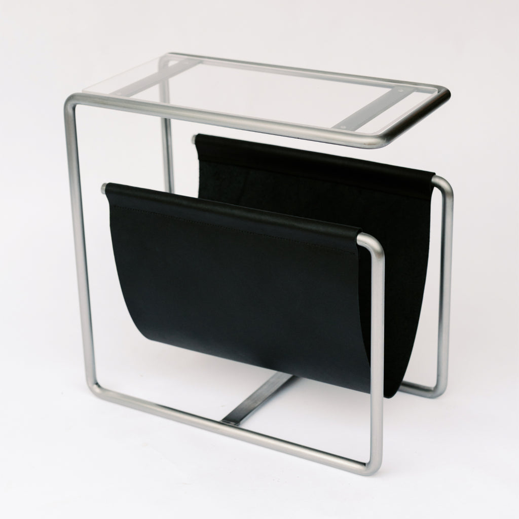 Raw cold rolled steel and black full-grain leather magazine rack side table with tempered glass top