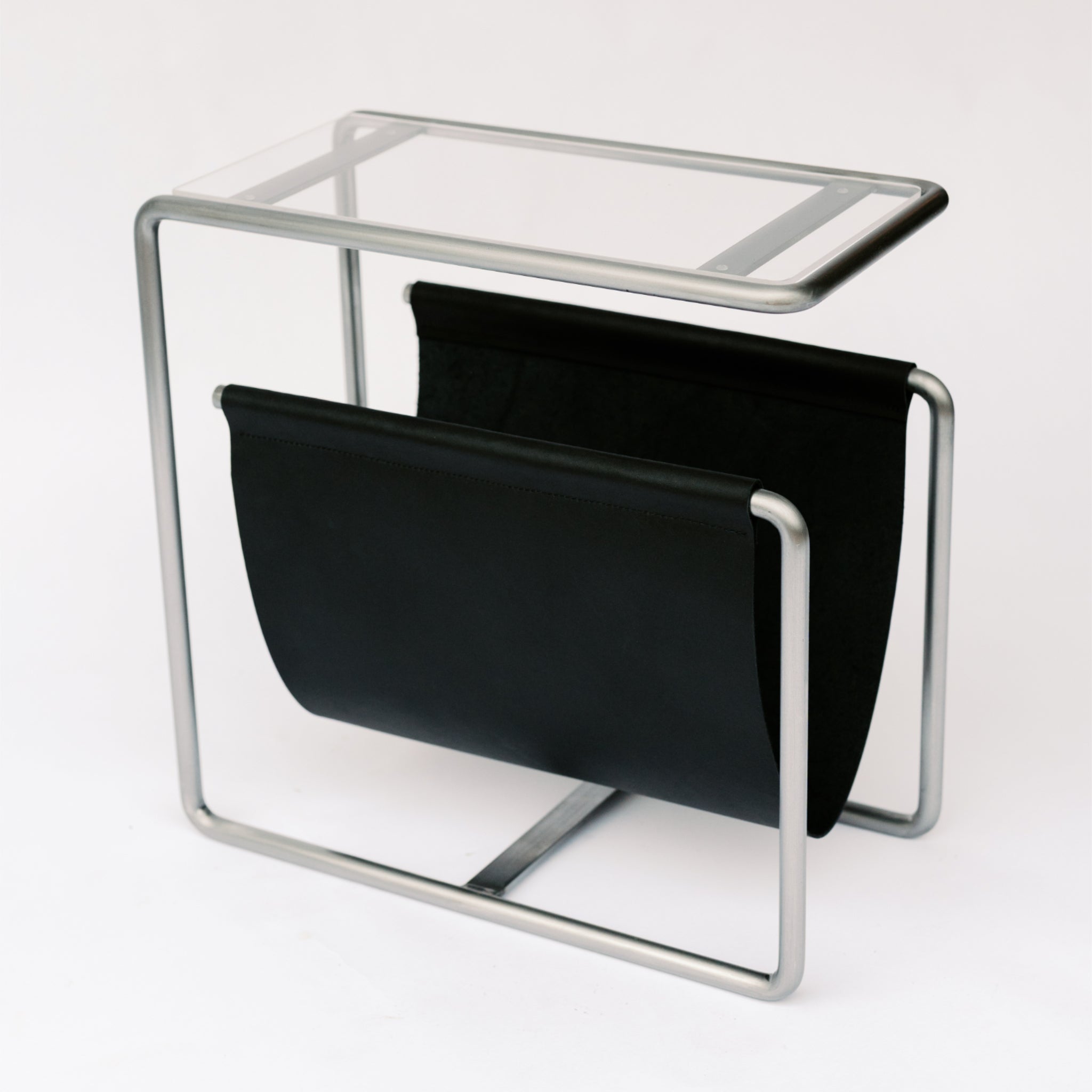 Raw cold rolled steel and black full-grain leather magazine rack side table with tempered glass top