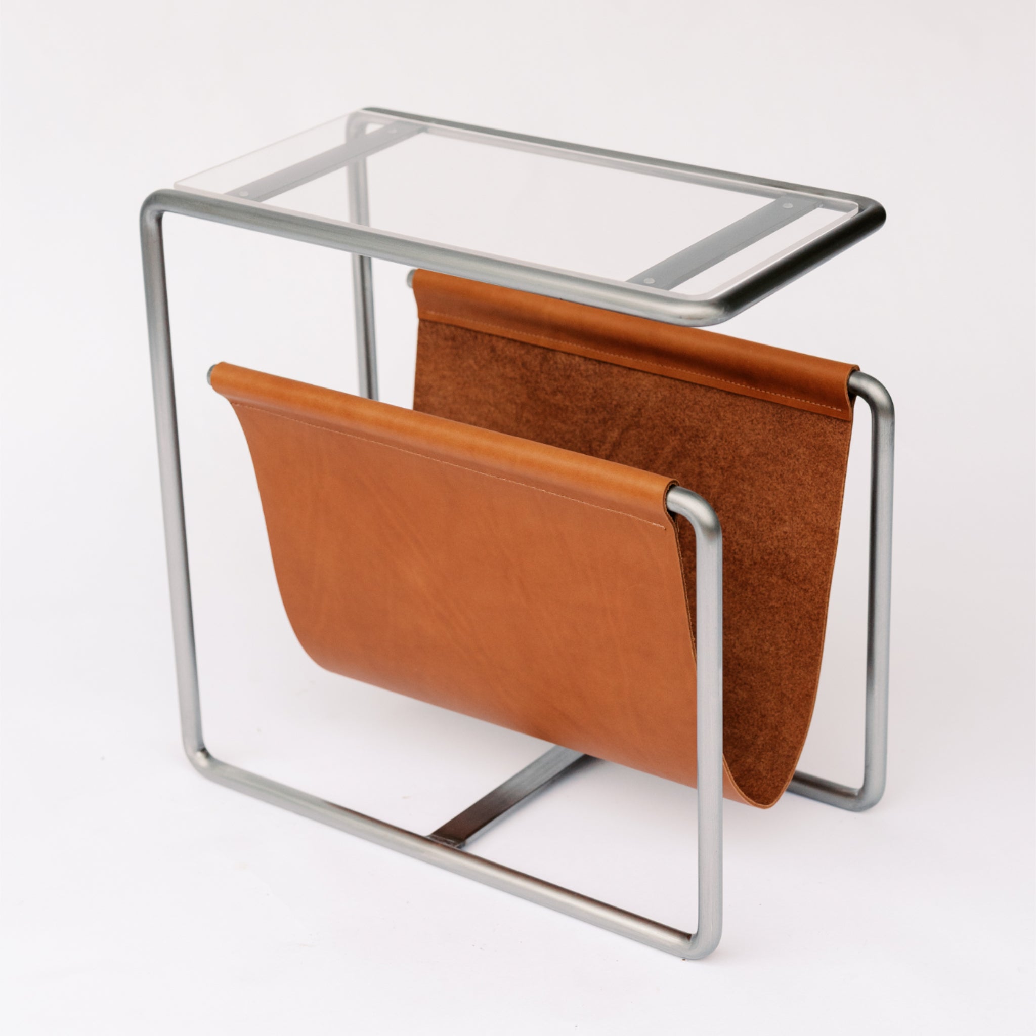 Raw cold rolled steel and caramel full-grain leather magazine rack side table with tempered glass top
